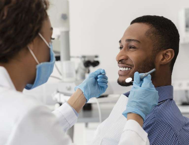 man smiling during professional teeth cleaning in Doylestown PA