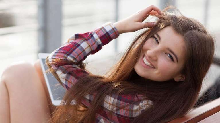 Young woman in Doylestown smiles with her newly corrected front teeth