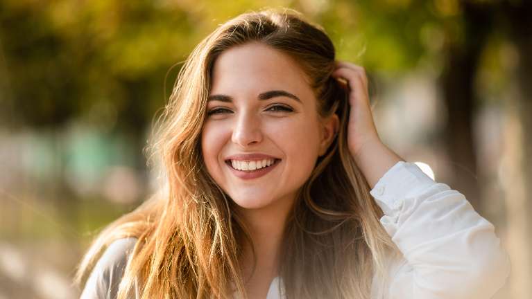 A woman with a bright smile on her face